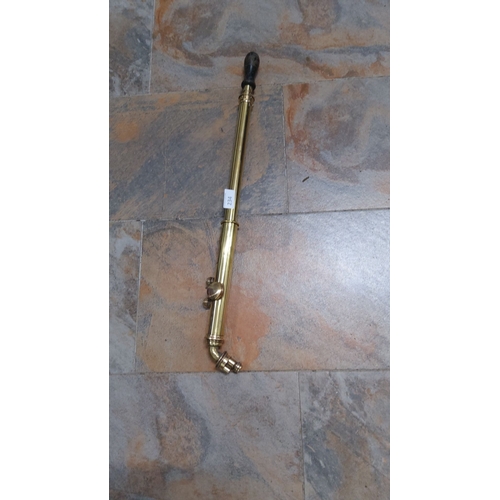 234 - Antique brass pump with wooden handle, featuring a traditional coiled design.(immaculate condition)