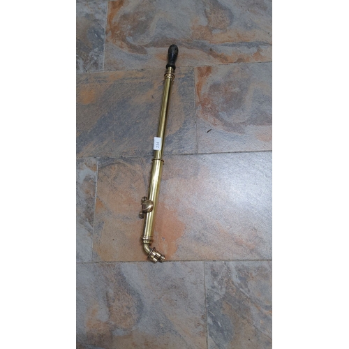 234 - Antique brass pump with wooden handle, featuring a traditional coiled design.(immaculate condition)