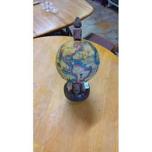 24 - Vintage-style globe with decorative wooden stand, featuring an antique map design.