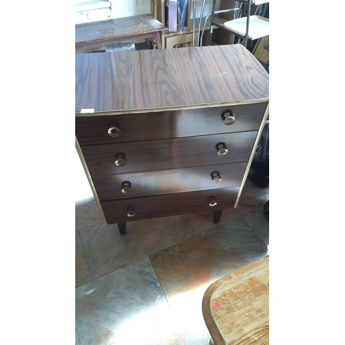 261 - Mid-Century Modern four-drawer chest with brass handles and decorative trim. Wood finish with grain ... 