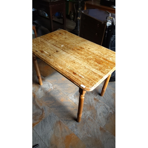 263 - Rustic wooden dining table features turned legs and a rectangular top. The piece showcases a natural... 