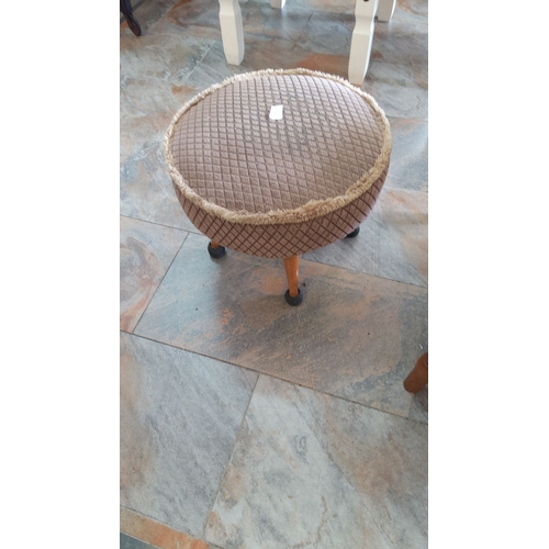 271 - Circular upholstered footstool with diamond-patterned fabric and fringe trim, supported by 4 wooden ... 