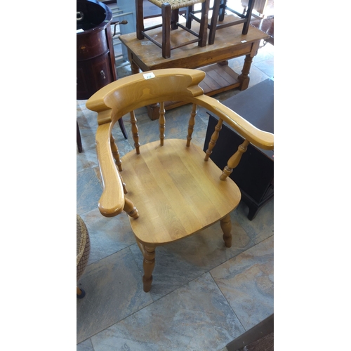 272 - Solid oak captain's chair with shaped backrest and turned spindle legs. Classic and sturdy design.