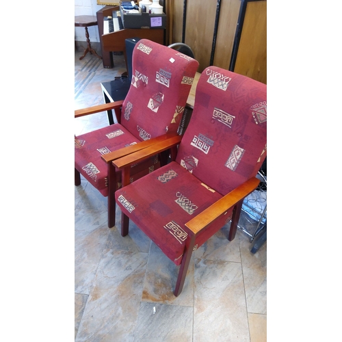 276 - Pair of mid-century modern upholstered armchairs with wooden frames. The red fabric features a geome... 