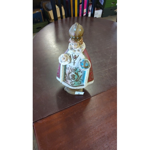 3 - Hand-painted ceramic figurine depicting the Infant Jesus of Prague, adorned in ornate ceremonial rob... 