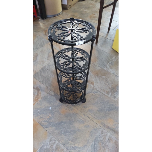 332 - Wrought iron multi-tier plant stand with intricate floral cutout design. Features three sturdy shelv... 