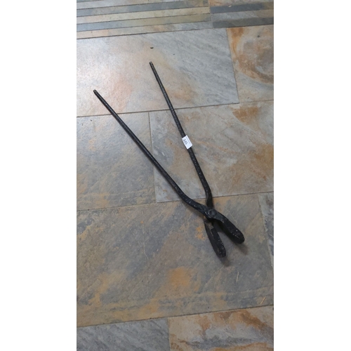 345 - Antique wrought iron blacksmith tongs with long handles measure approximately 26 inches.