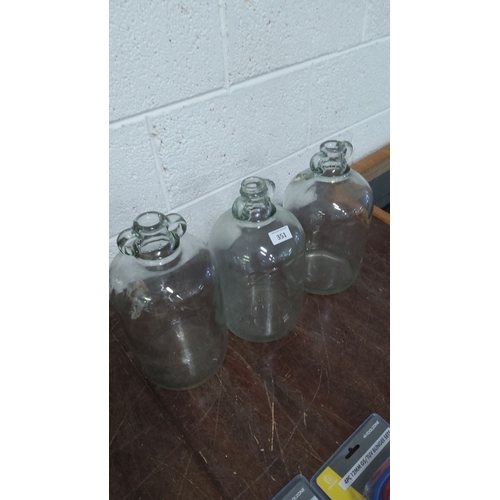 351 - Set of three vintage glass demijohns with handled tops.