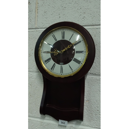 362 - Dark wood quartz wall clock featuring Roman numerals and ornamental gold-tone hands.