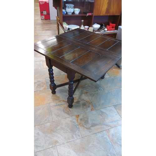 368 - Barley twist oak gateleg table, from the early 20th century. Features extendable leaves and dark sta... 