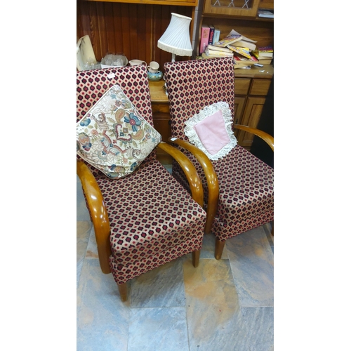 373 - Pair of mid-century modern armchairs with patterned upholstery and curved wooden armrests. Includes ... 