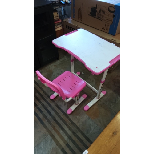 375 - Pink and white desk and chair set features a spacious work surface and ergonomic chair design.