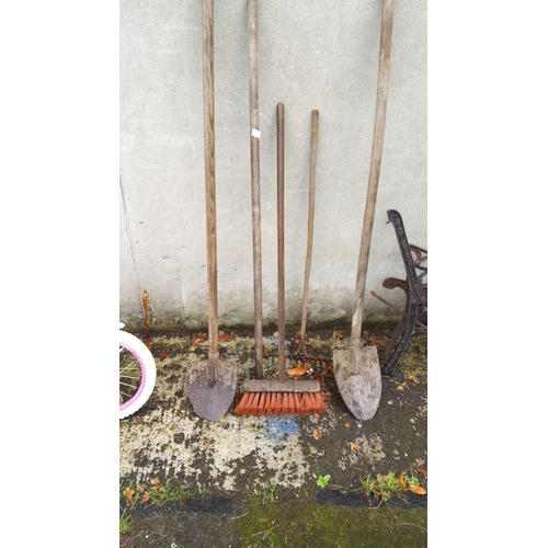 389 - Collection of five wooden-handled garden tools, including two shovels, a rake, a broom, and a spade.