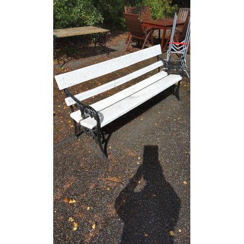 401 - White wooden outdoor park bench with ornate black cast iron sides. Classic design.