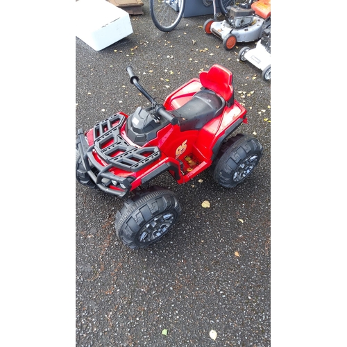 410 - Red ride-on ATV with number 95 decals, featuring a durable black plastic framework and large rugged ... 