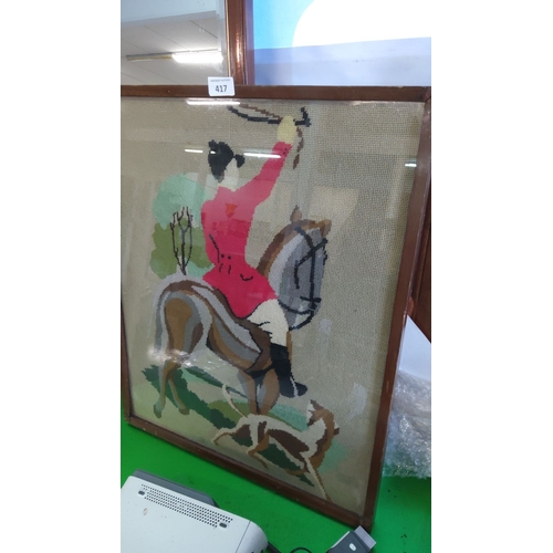 417 - Framed needlepoint of a hunt scene, featuring a rider in a red coat on horseback with hounds, housed... 