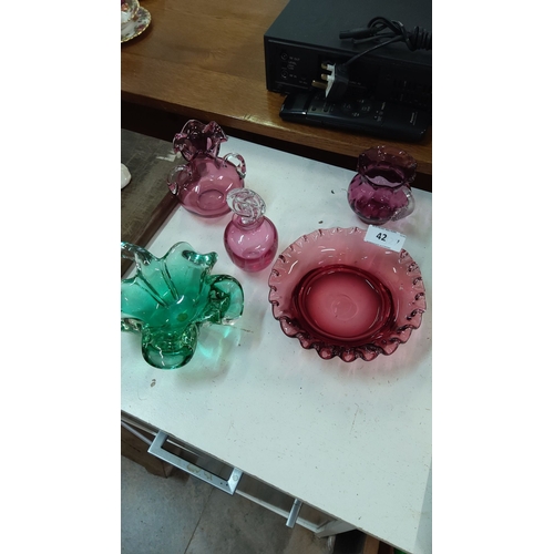 42 - Collection includes two pink ruffled vases, one green fluted bowl, one pink perfume bottle, and two ... 