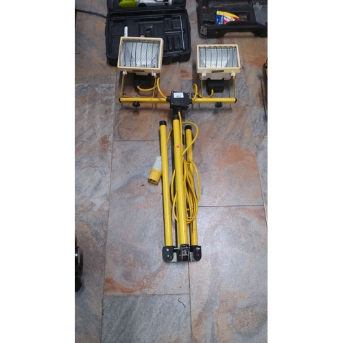 457 - Dual portable work lights on adjustable tripod stand, yellow finish.