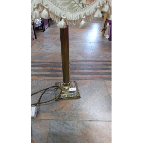 47 - Vintage floral lampshade on brass table lamp with tassel fringe, featuring a detailed square base.