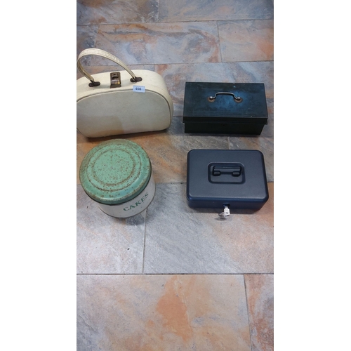 498 - Set of four vintage boxes includes a cream-colored travel case, a green tin cake box, a black metal ... 