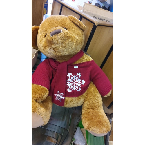 501 - Large plush bear wearing a red sweater with white snowflake designs.