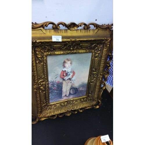 76 - Vintage print of a young child holding a small dog, set in an ornate gold Victorian-style frame.