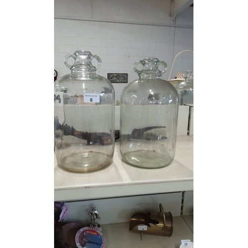 8 - Pair of vintage clear glass demijohns with twin handles. Height: Approx. 20 inches each.