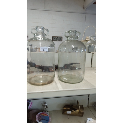 8 - Pair of vintage clear glass demijohns with twin handles. Height: Approx. 20 inches each.