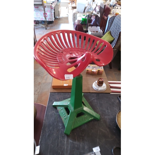 145 - Vintage stool with a red metal tractor seat mounted on a green cast iron singer sewing machine base.