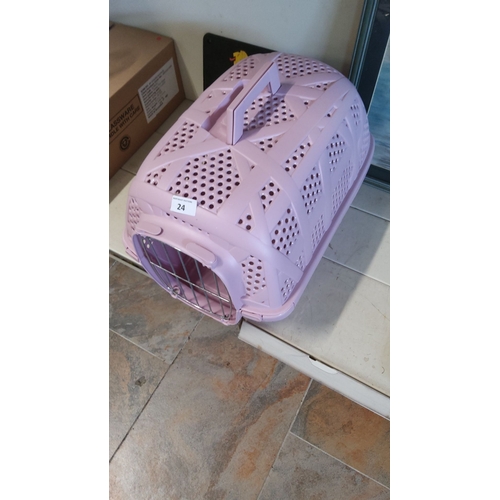 24 - Pink plastic pet carrier with handle and metal wire front gate. Ventilated design.