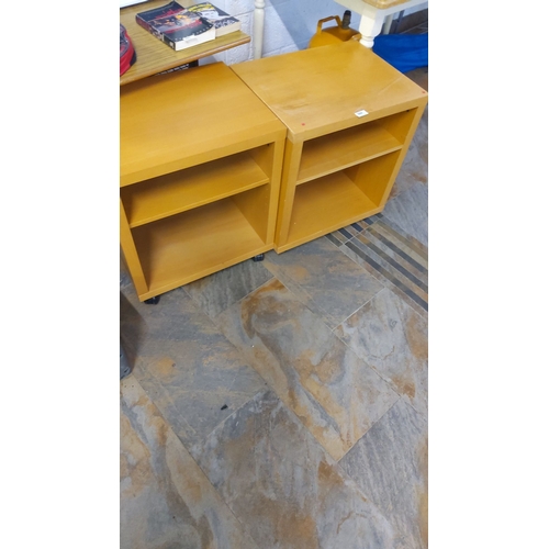 384 - Pair of light oak-finish lockers with a single adjustable shelf in each unit on caster wheels.