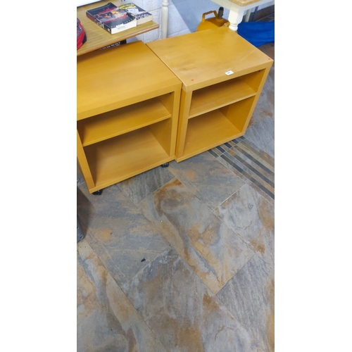 384 - Pair of light oak-finish lockers with a single adjustable shelf in each unit on caster wheels.