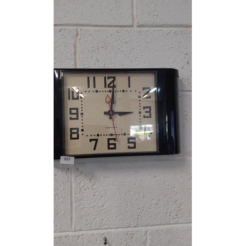 387 - Newgate wall clock with a classic black and white design, featuring bold numerals and a marked red s... 