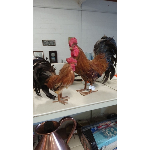 6 - Pair of decorative rooster figurines with realistic feathers and vibrant color detailing.