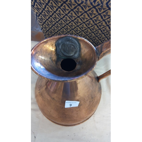 9 - Large vintage copper pitcher with handle, featuring a hallmark on the spout.