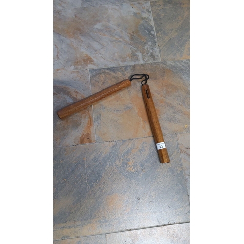 12 - Vintage wooden nunchaku with a connected cord, showing classic martial arts design, made from durabl... 