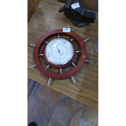 130 - Barometer in polished wood and chrome, shaped like a ship's wheel, marked with weather conditions fr... 