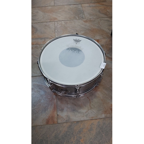 131 - Vintage Remo snare drum with a chrome-plated shell, featuring a white drumhead stamped with the Remo... 