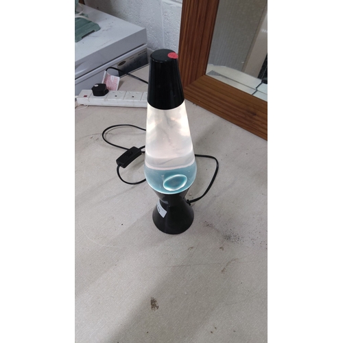 145 - Black lava lamp with clear liquid and white wax.(pwo)