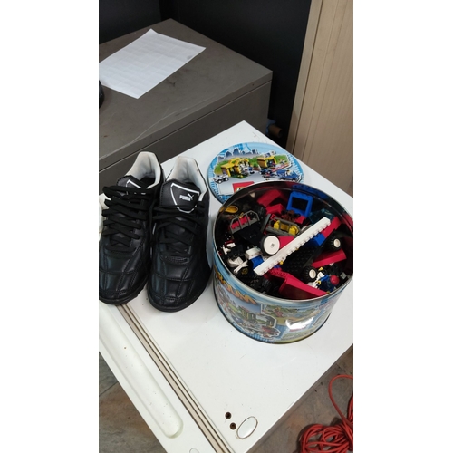 151 - Mixed lot features a pair of black Puma sneakers (7)and a tin filled with assorted LEGO pieces, incl... 