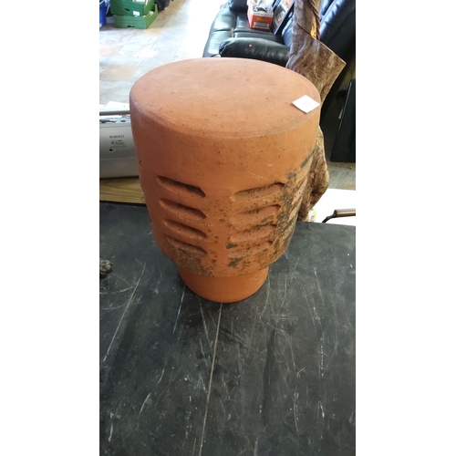 158 - Terracotta chimney pot, featuring a cylindrical shape and slotted design.