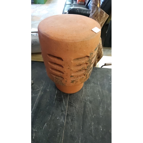 158 - Terracotta chimney pot, featuring a cylindrical shape and slotted design.