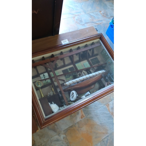 173 - Wooden-framed shadow box showcases a maritime diorama, featuring detailed nautical instruments, coil... 