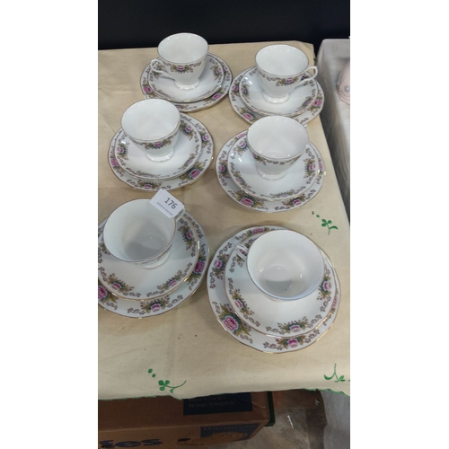 176 - Set of six china trios with floral patterns and gold trim.