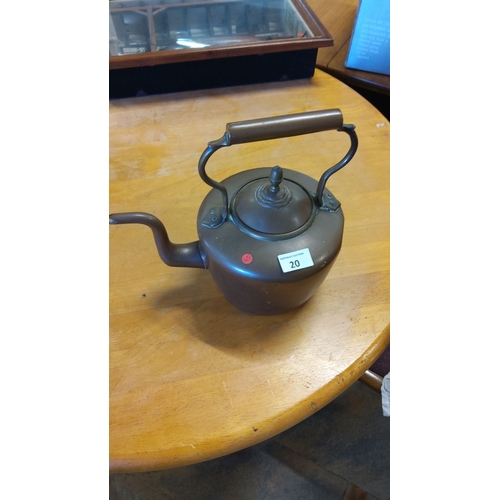 20 - Vintage copper kettle with a curved spout and wooden handle. Features a matching lid.From the early ... 