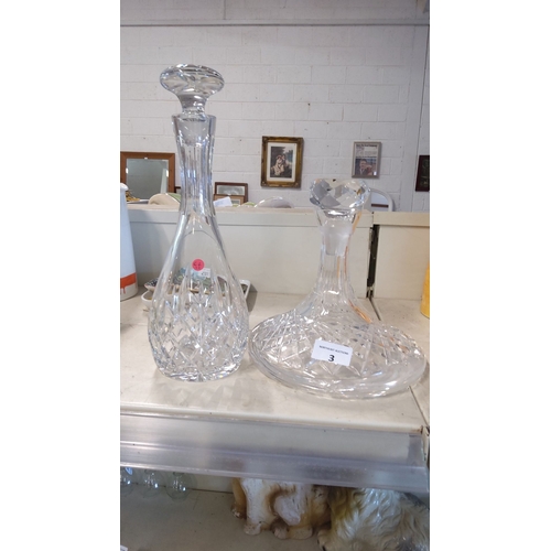 3 - Pair of intricately cut crystal decanters featuring elegant designs and clear stoppers.(1 Galway)