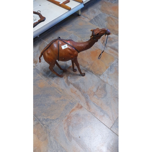 32 - Large leather camel figurine,featuring intricate carving and attention to detail.