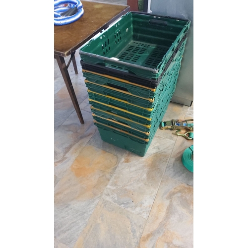 472 - Stack of 9 green plastic storage crates with collapsible sides.