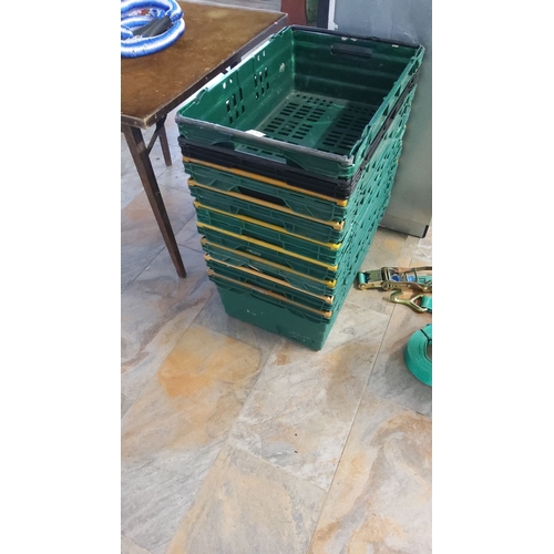 472 - Stack of 9 green plastic storage crates with collapsible sides.