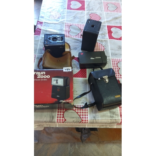 486 - Mixed lot of vintage cameras and accessories including a Braun 2000 flash unit, leather camera cases... 